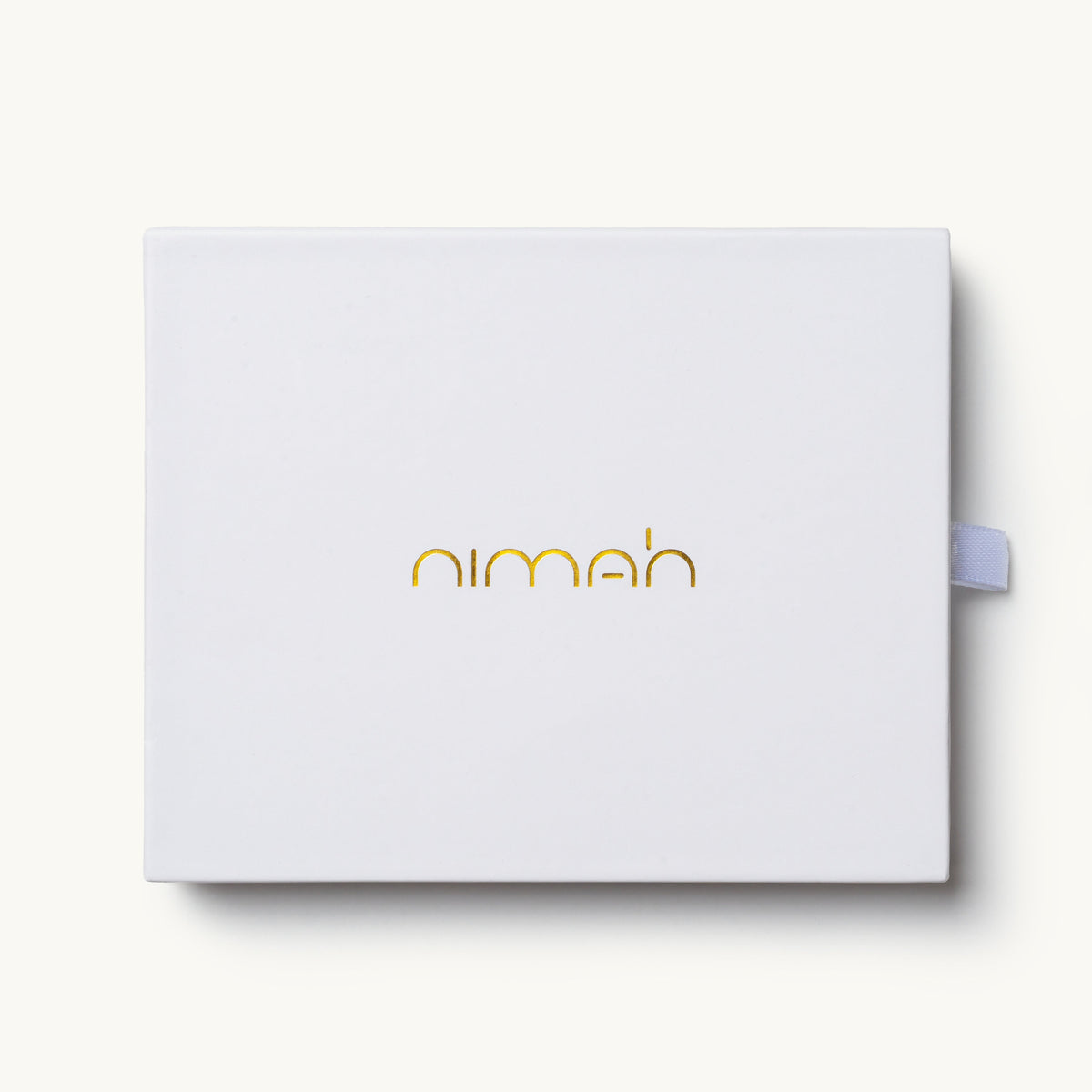 A white rectangular product box with the brand name 'nimeh' printed in a gold metallic font on the front, set against a light off-white background.