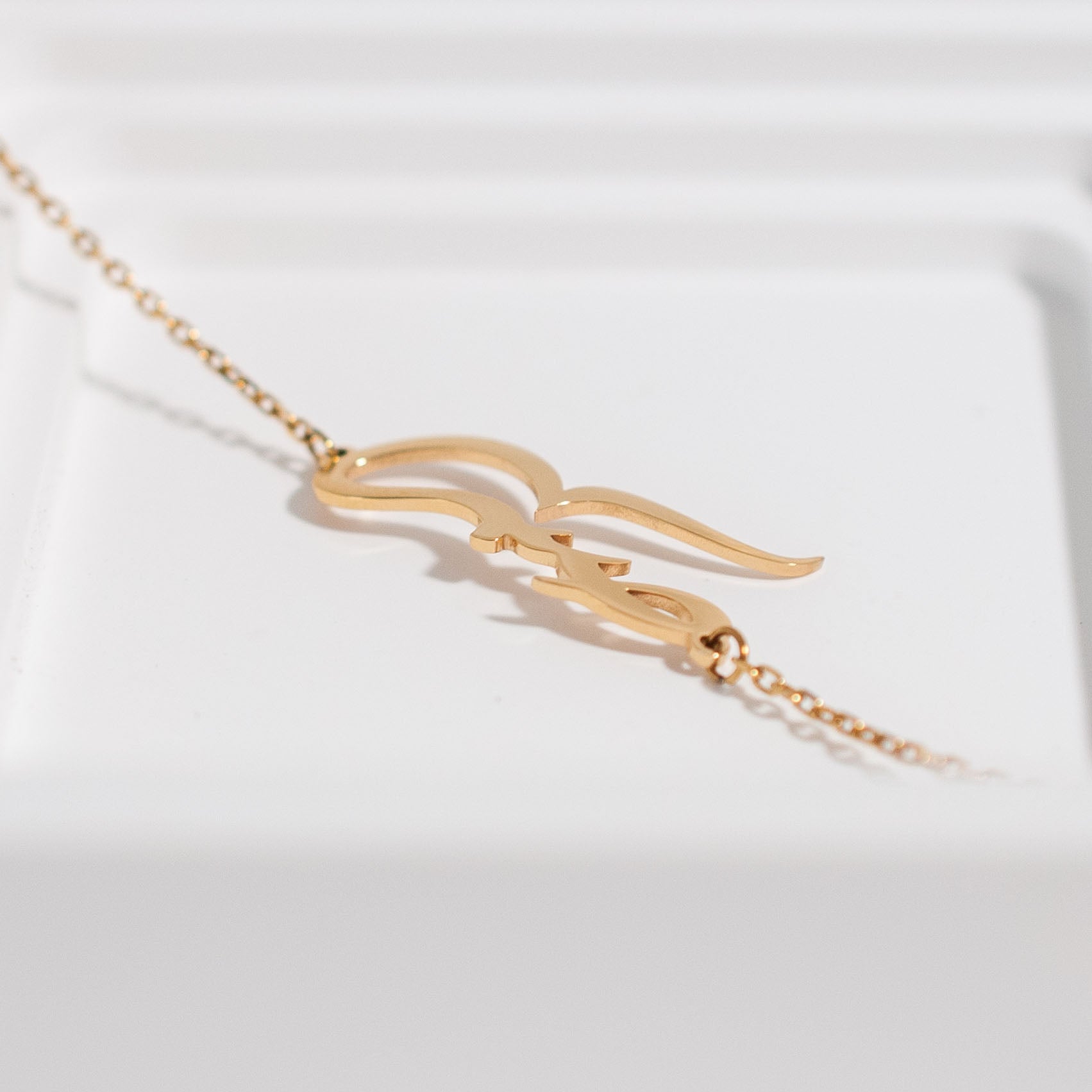 close up of 'patience' Arabic bracelet