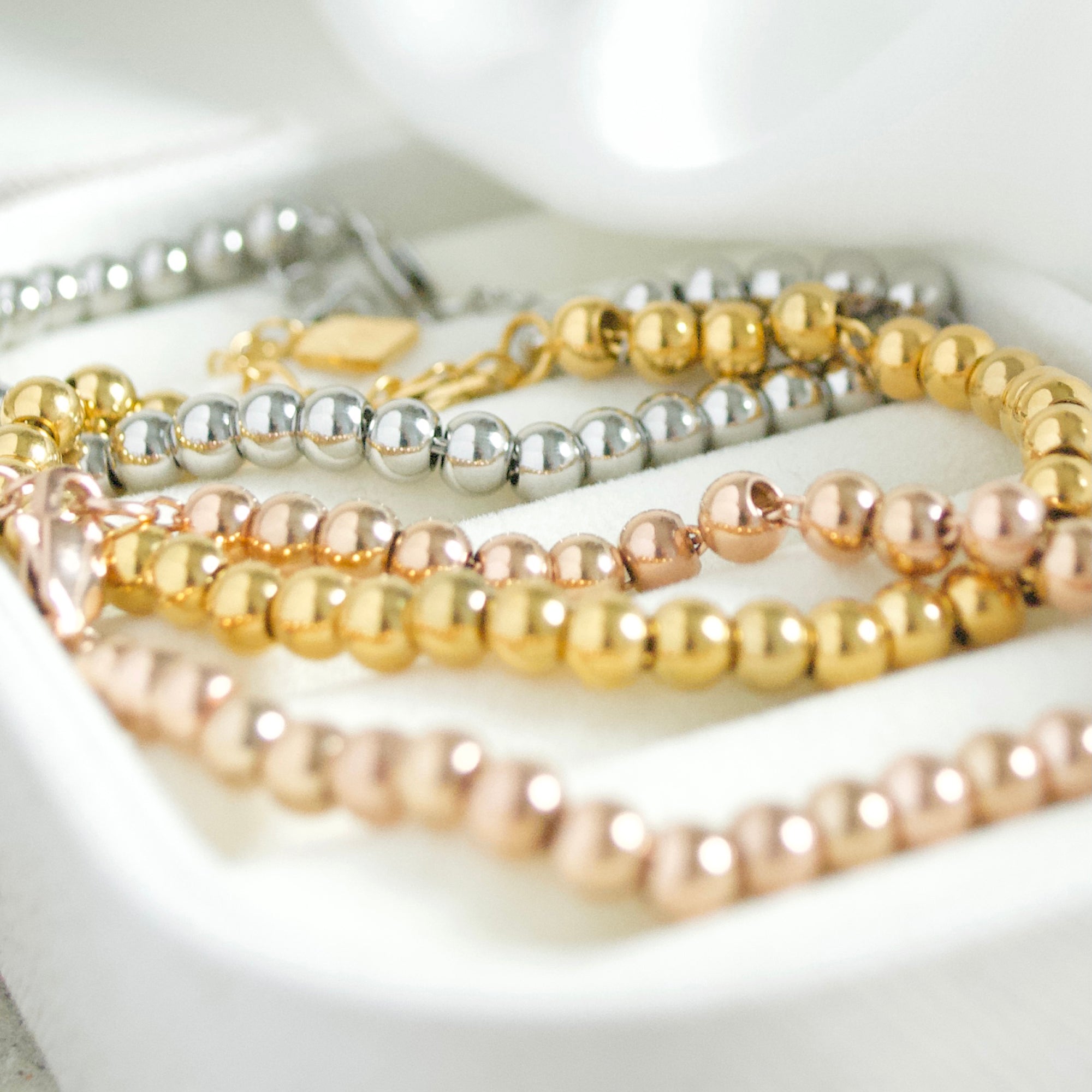 Trio of dainty islamic bracelets in gold, silver and rose gold