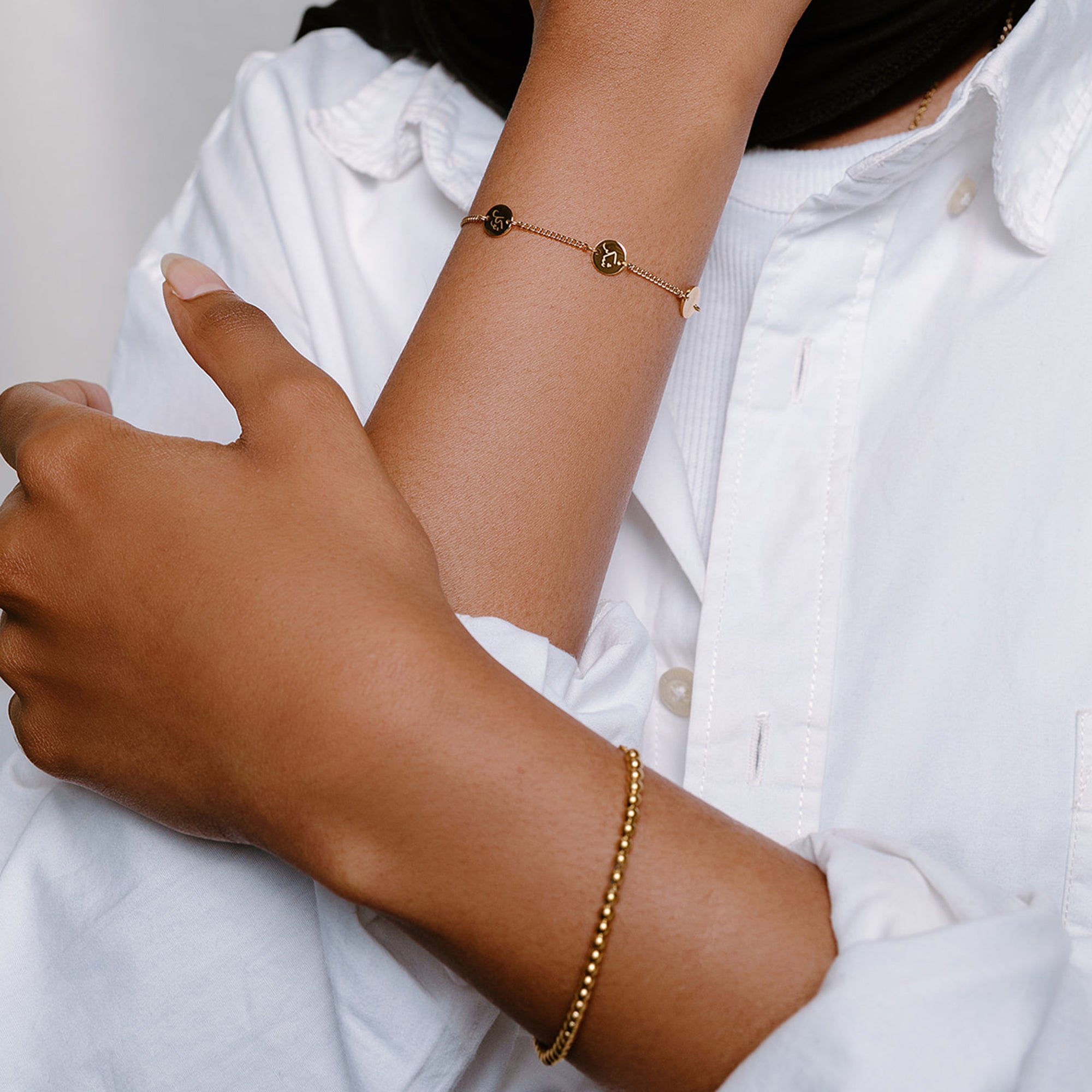 Model wearing engraved Arabic gold bracelet