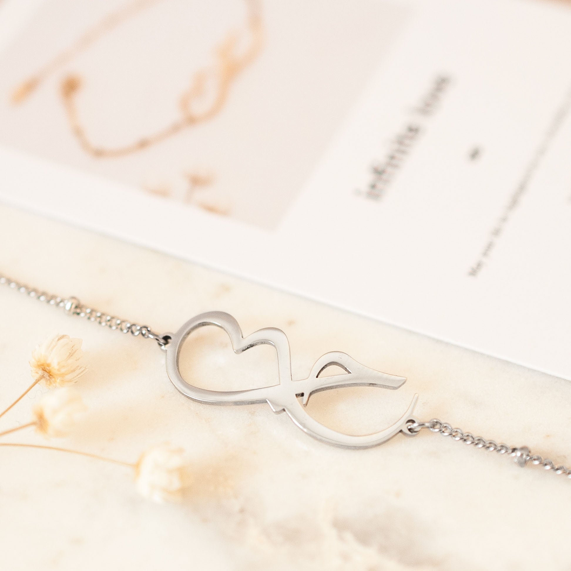 Close up of Arabic silver bracelet with infinity love symbol