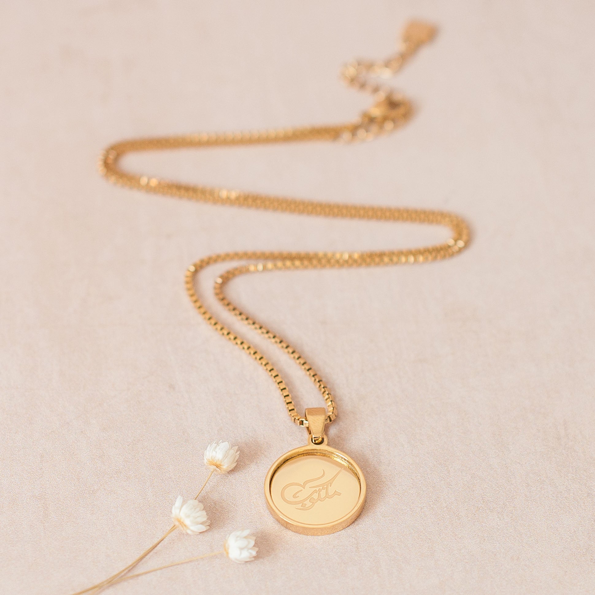 Nimah "Its Written" Arabic Calligraphy Necklace With 18K Gold Plated Displayed On White Ground 