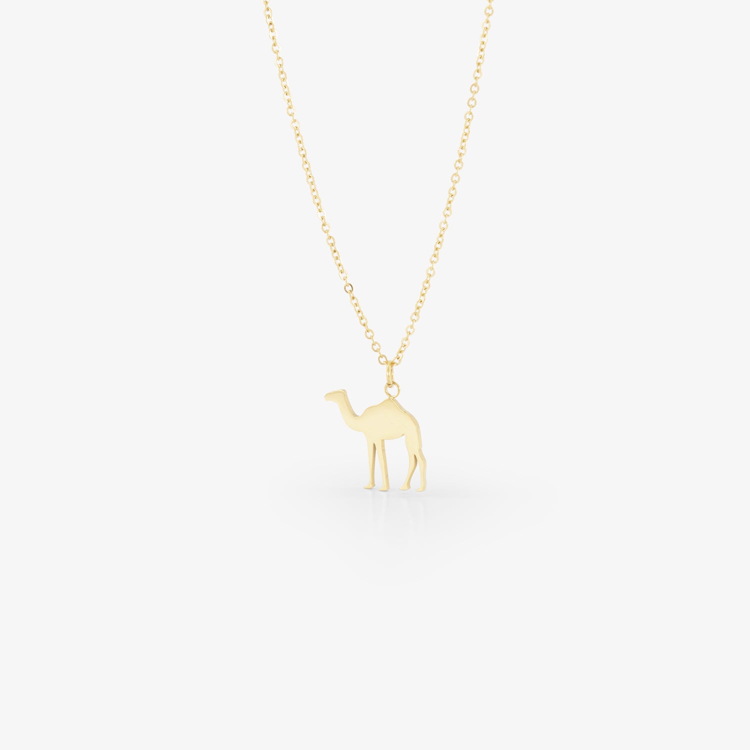 image of gold camel necklace on white background