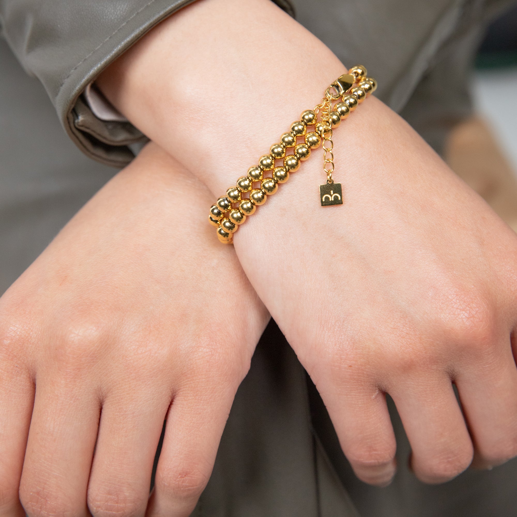 A pair of beaded islamic bracelets with Nimah London logo engraved