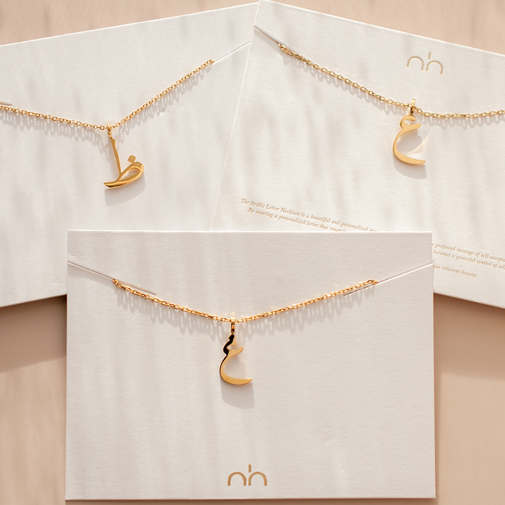 Nimah Arabic Letter Necklace With Ayn, Ghayn & Zaad Displayed With 18K Gold Plating