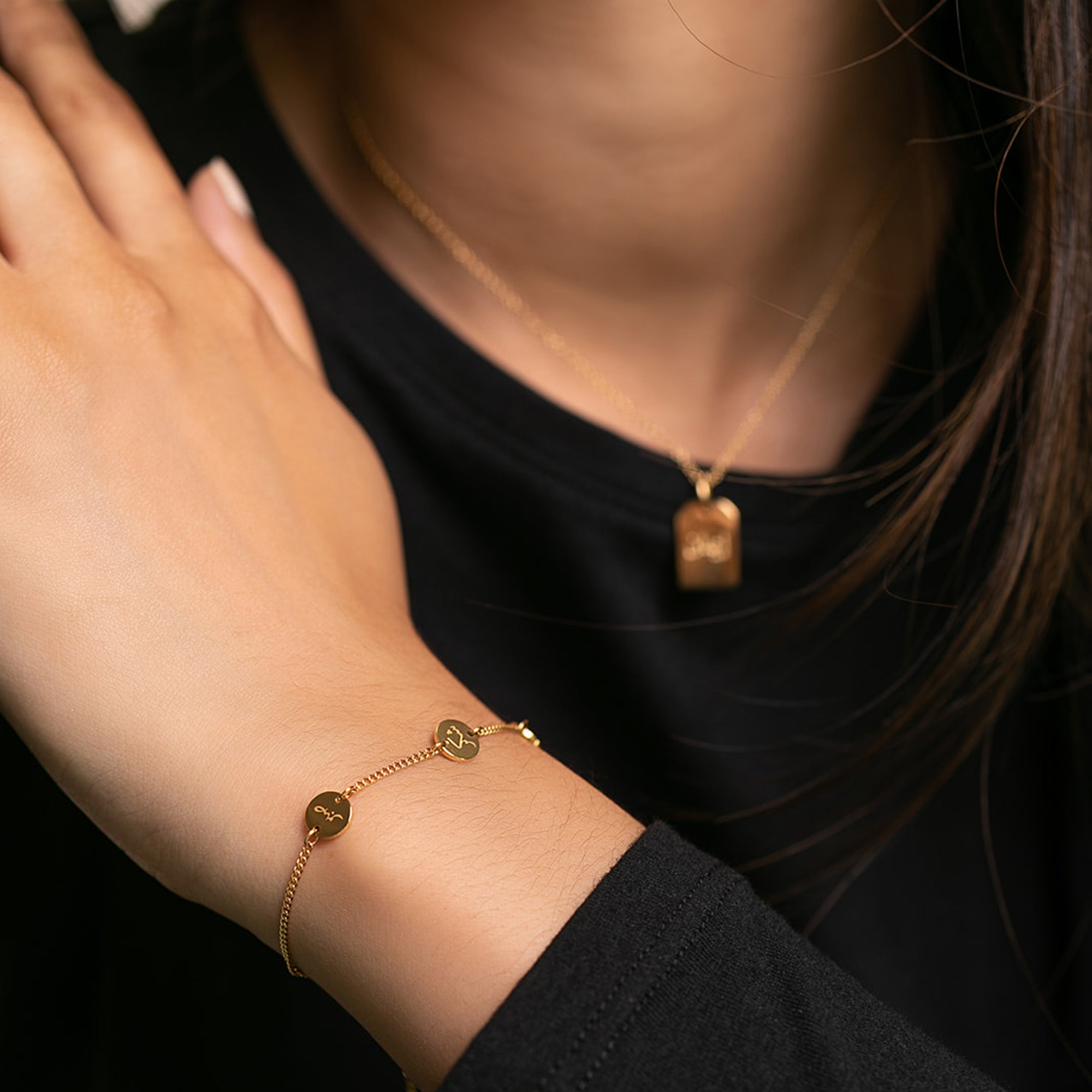 Model showing Arabic gold bracelet with multiple engravings saying 'happiness' in Arabic