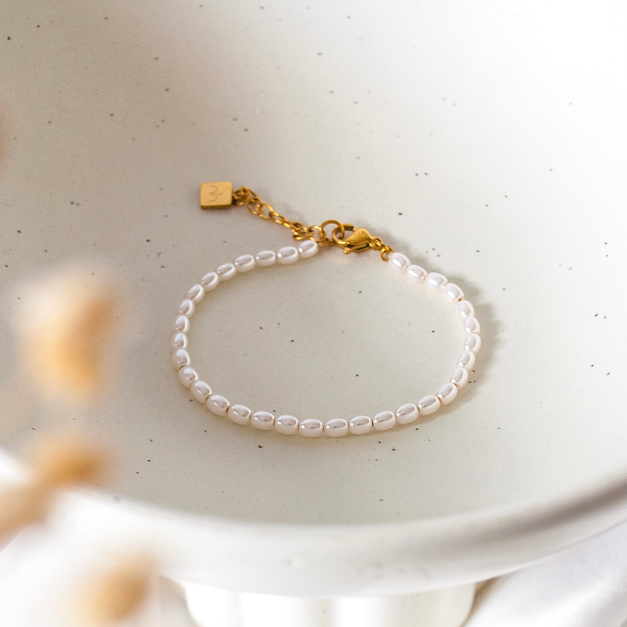 Pearl islamic bracelet with Niamh London's logo engraved on chain