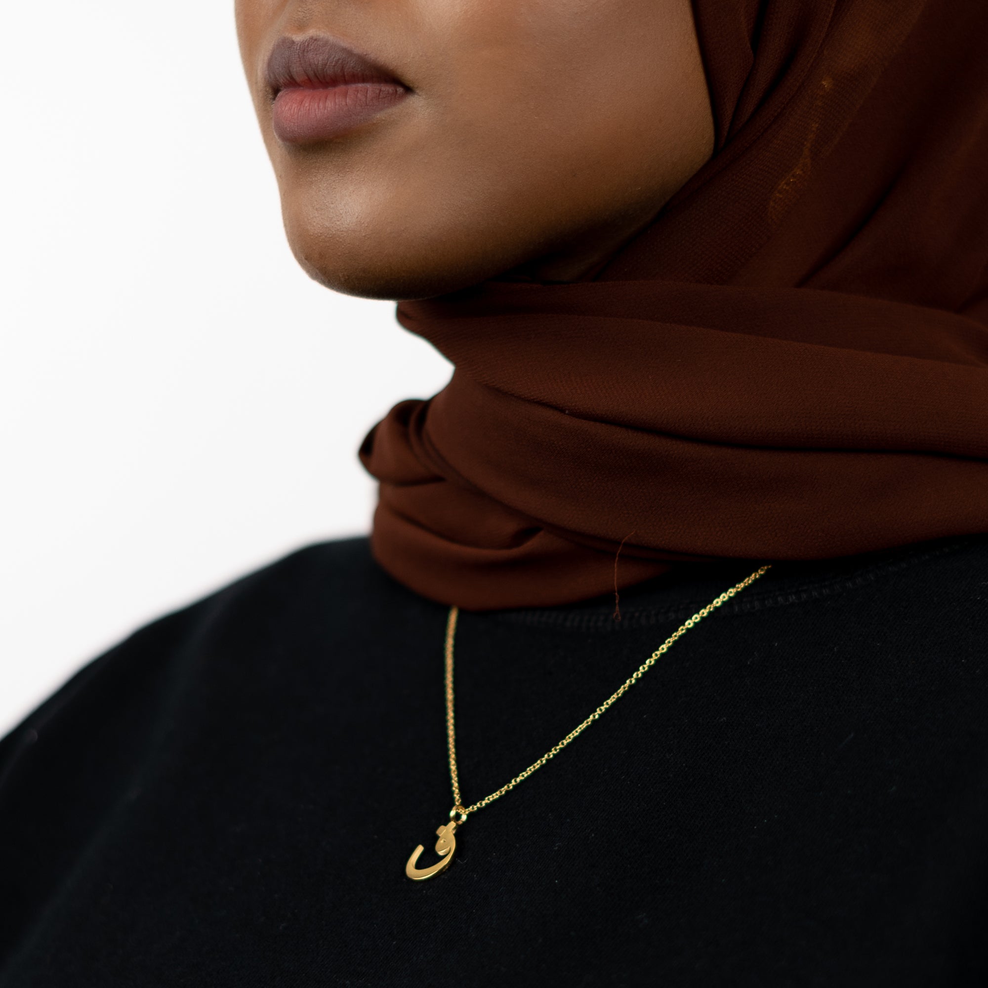 image of model wearing Arabic name necklace in 18K plated gold