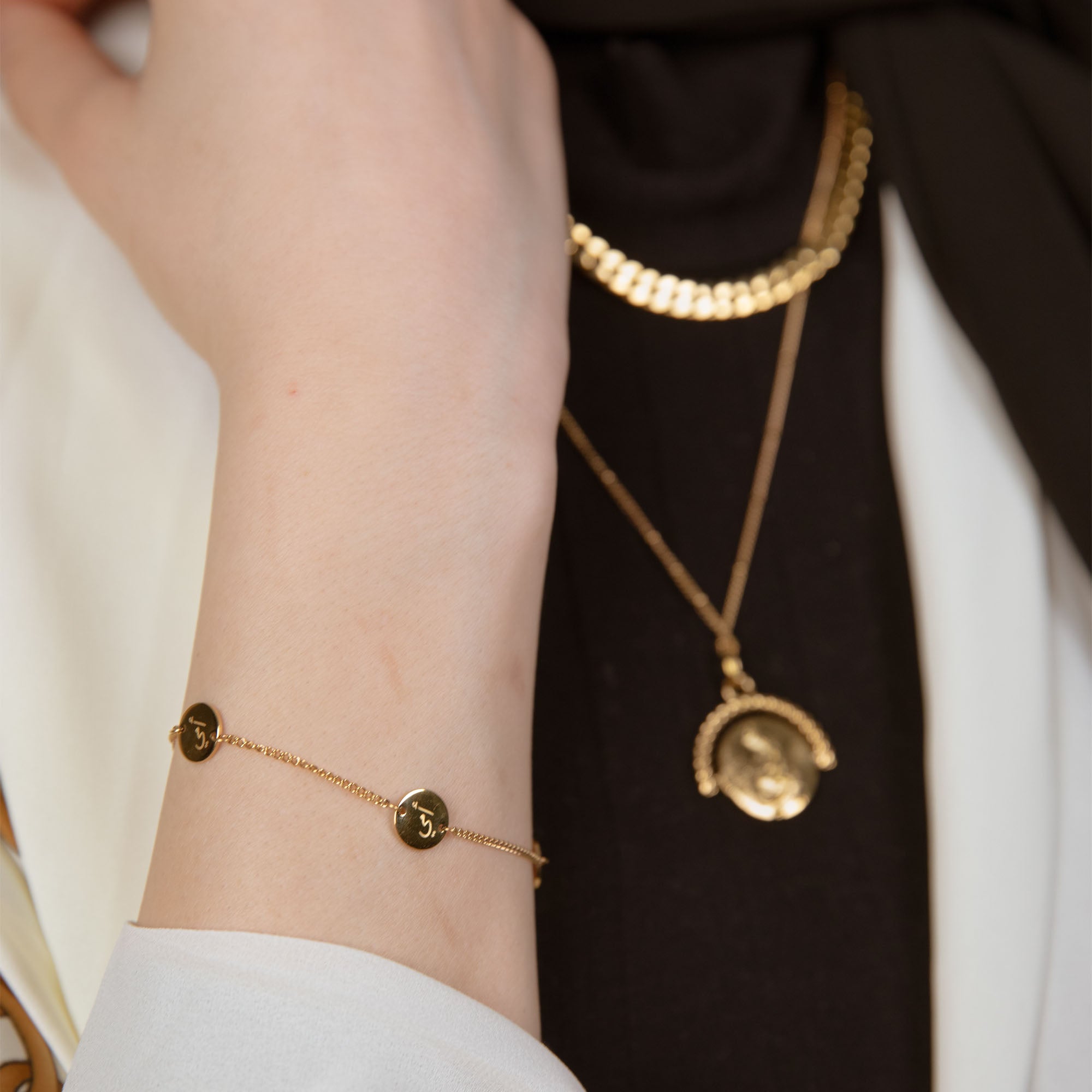 Model wearing 'Mother' engraved bracelet   arabic gold bracelet 
